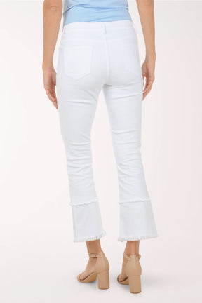 Person wearing white jeans on a plain background