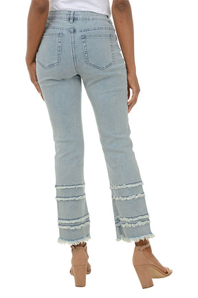 Light blue jeans with frayed hem worn by a person on a white background. Back shot.