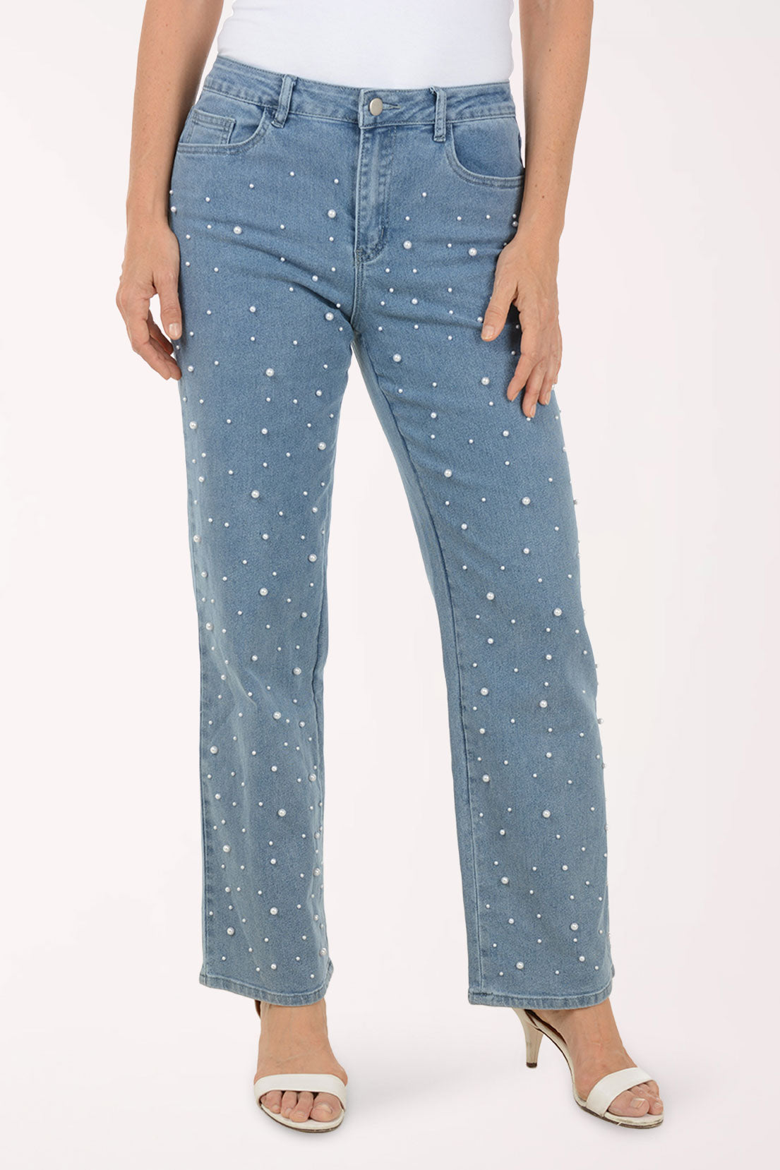 Person wearing blue jeans with white speckles on a white background