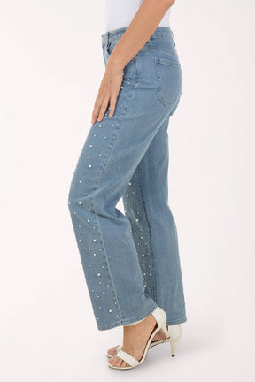 Person wearing blue jeans with white speckles on a white background