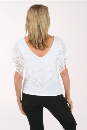 Woman wearing a white lace top and black pants on a white background