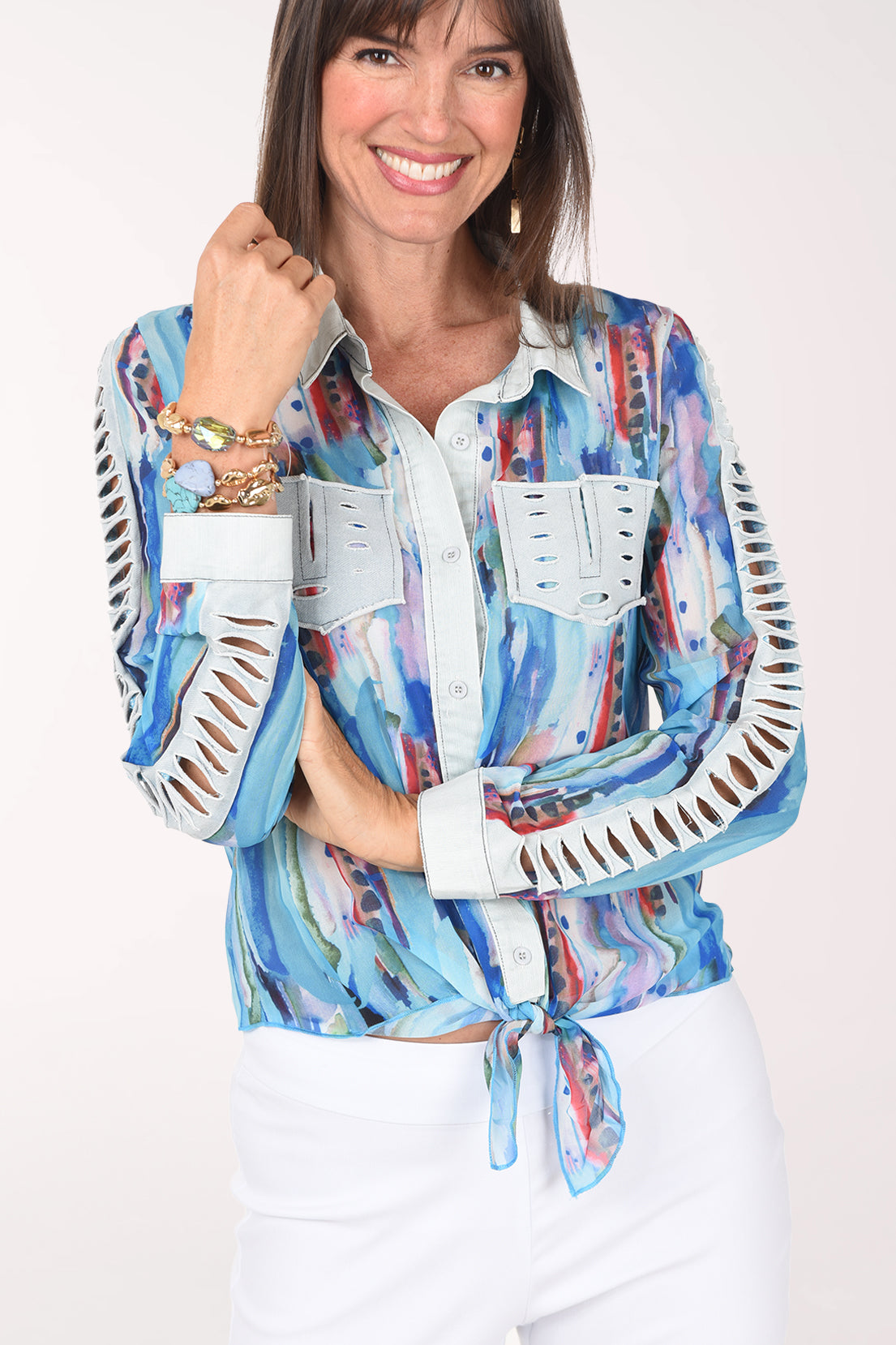 Front close-up of the turquoise watercolor shirt showing the denim faux pockets with distressed slits and the distressed denim cutouts down the sleeves.