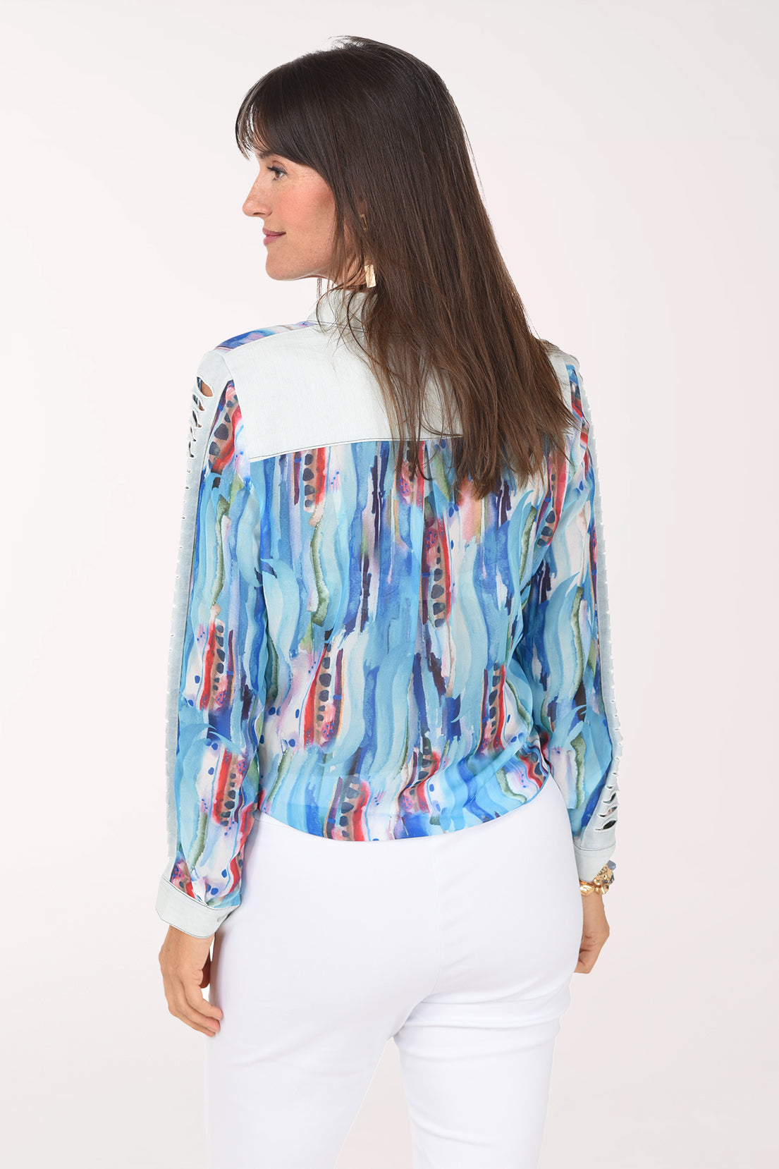 Back view of the turquoise watercolor shirt showing the light denim back yoke and pleated printed chiffon back.