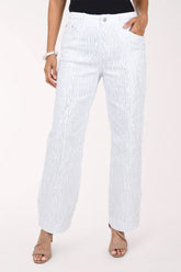 Front view of white stretch denim wide leg pants covered in fine vertical rows of silver rhinestones, with five-pocket styling, worn with a black top and nude heeled sandals.