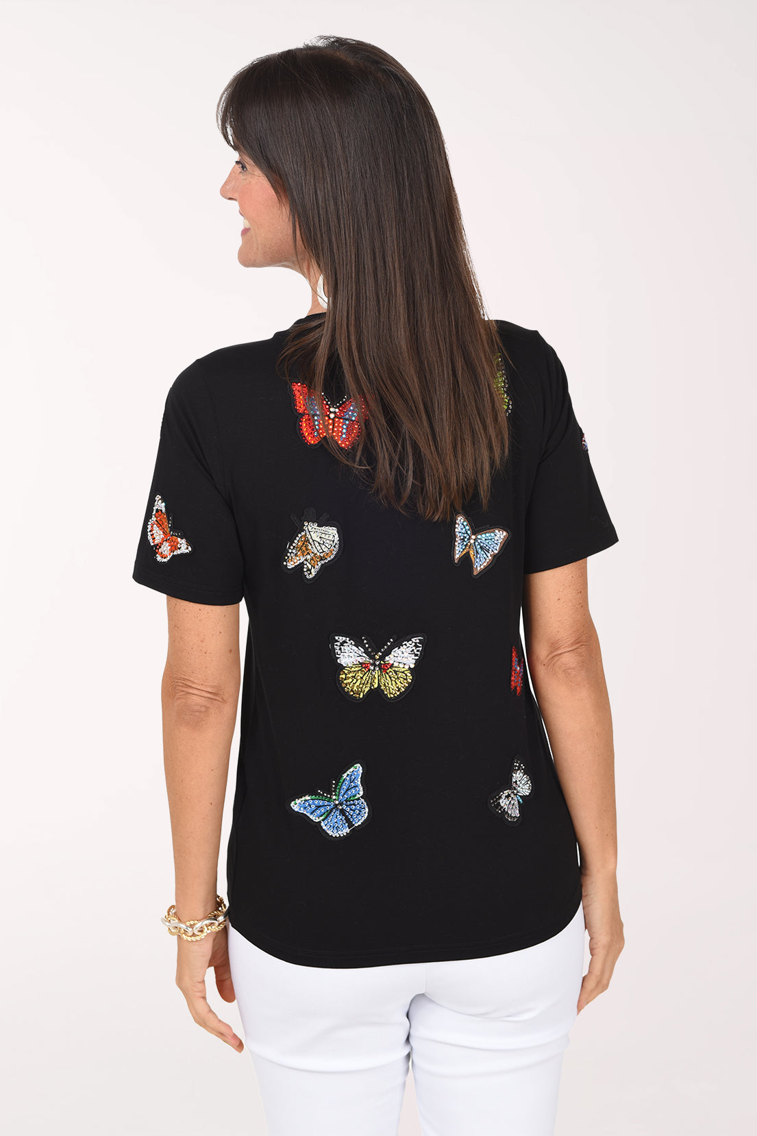Back view of the black butterfly tee showing more jeweled butterfly appliques across the back.