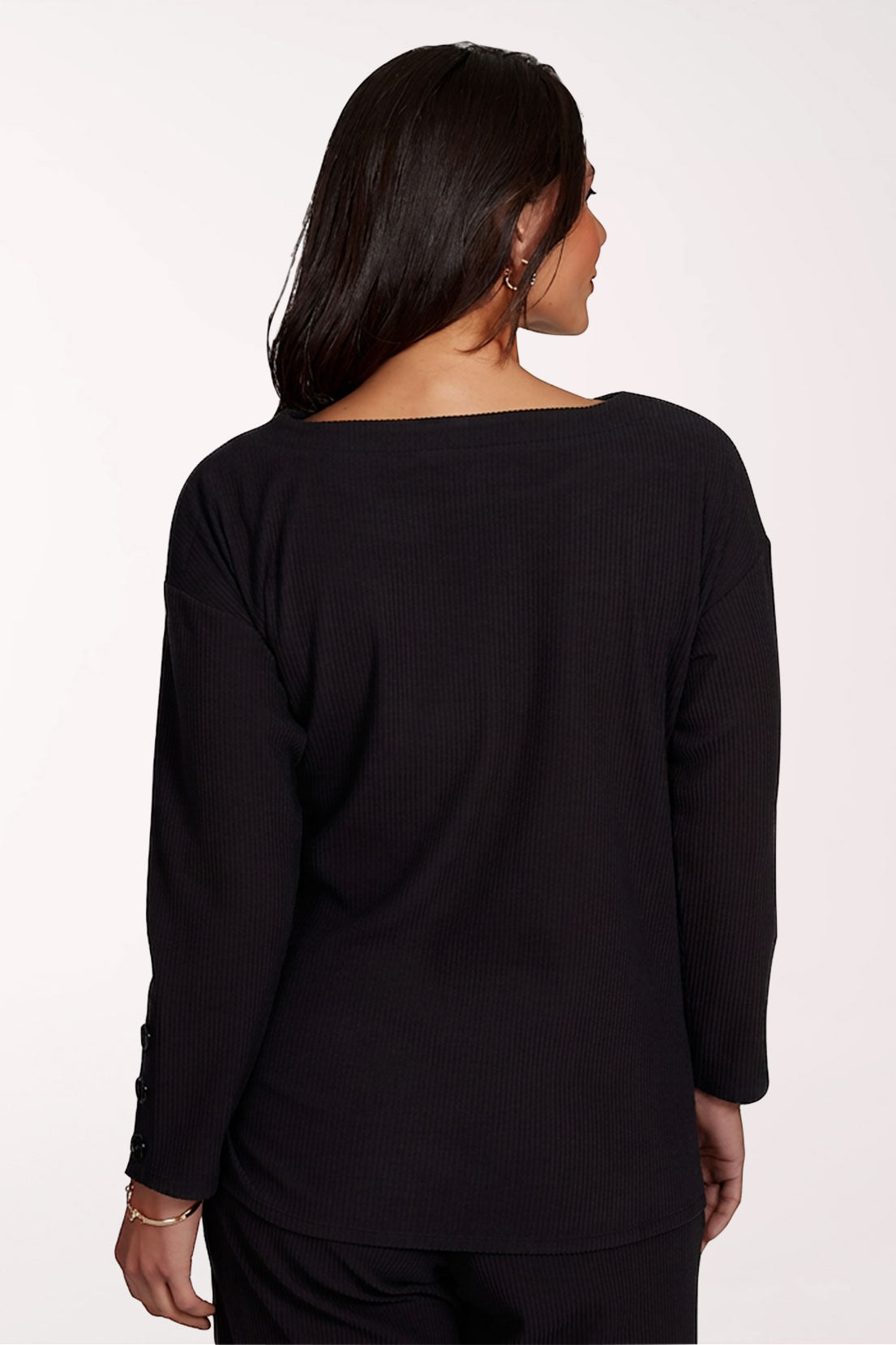 Woman wearing a black long sleeve wrap top
