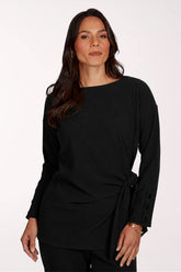 Woman wearing a black long sleeve wrap top