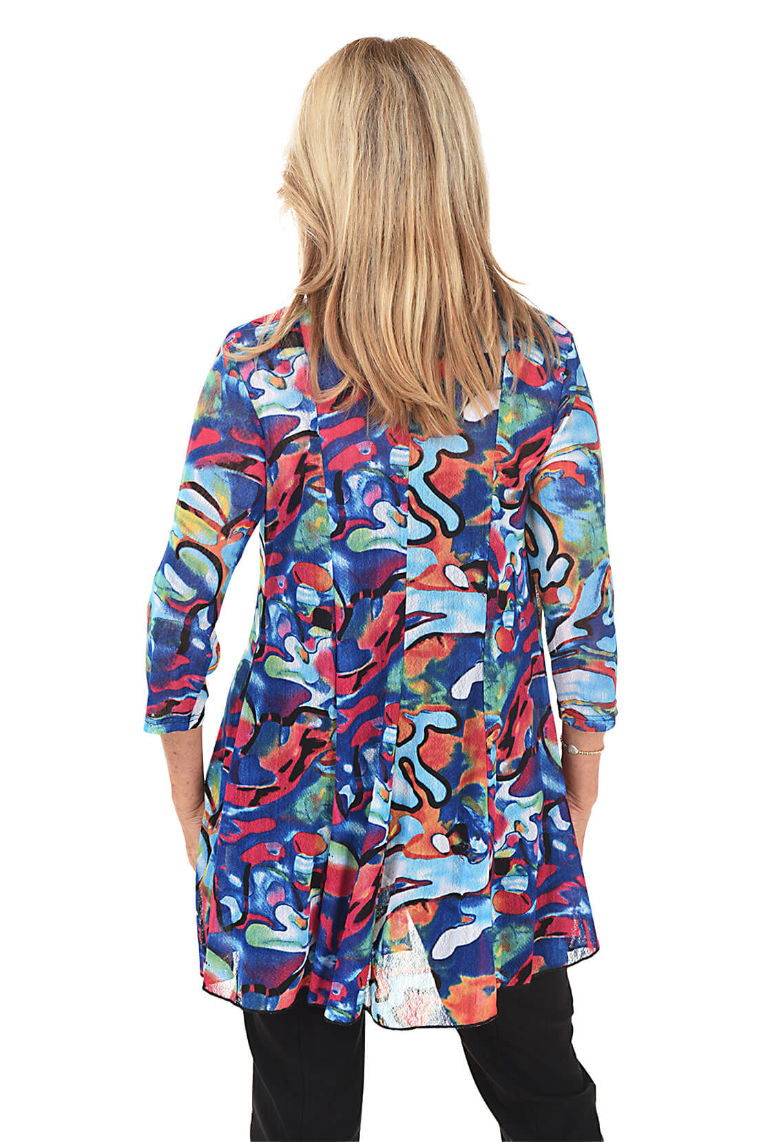 Woman wearing a colorful patterned cardigan on a white background. Back shot.