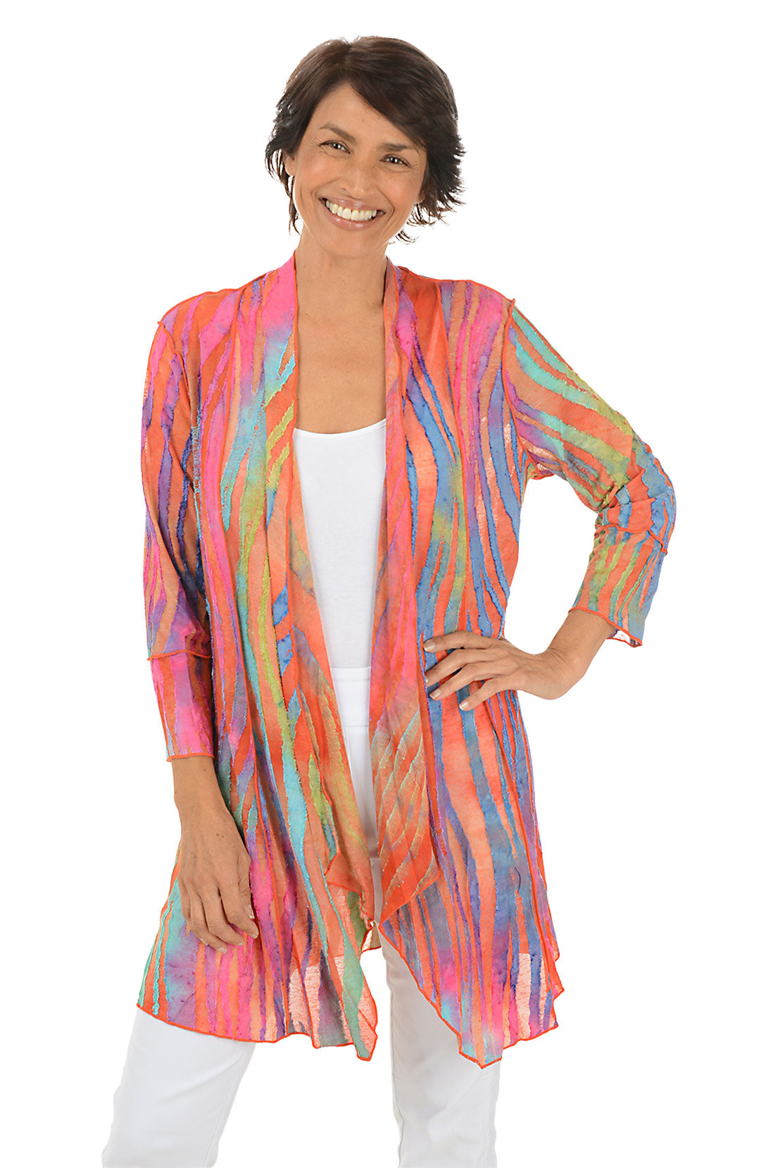 Woman wearing a colorful cardigan on a white background.