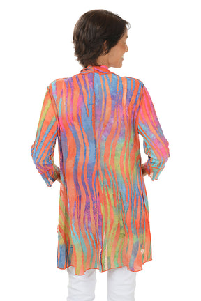Woman wearing a colorful cardigan on a white background. Back shot.