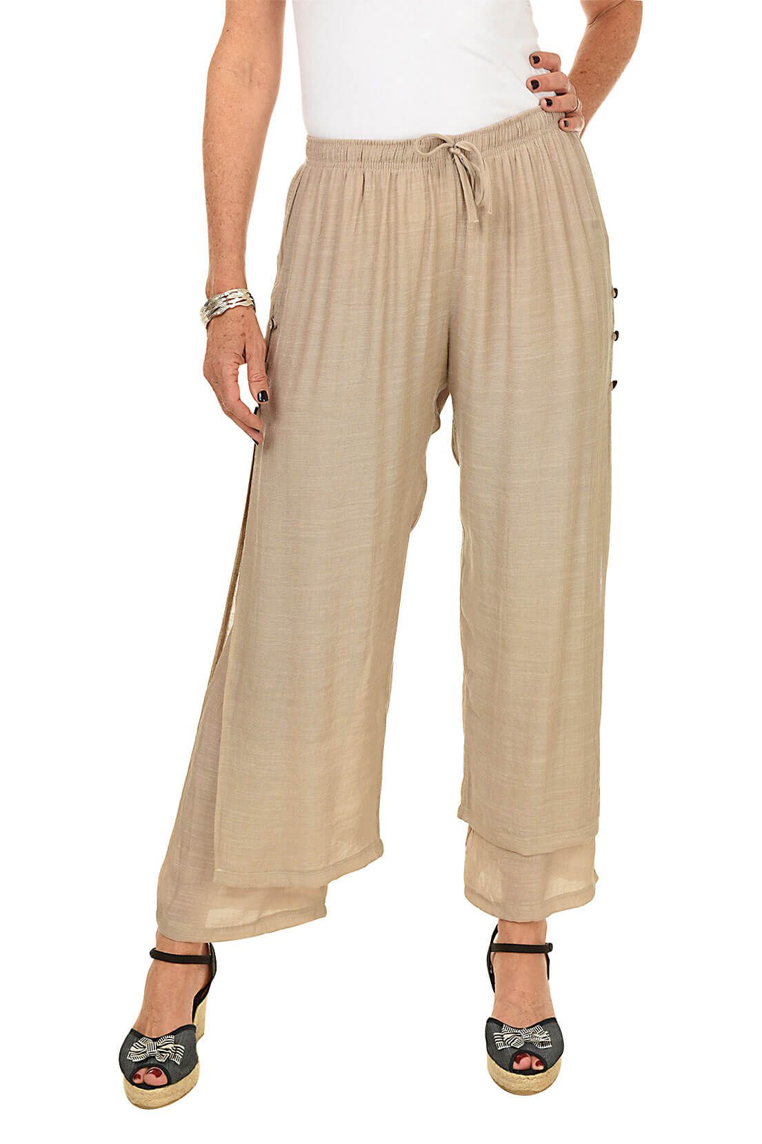 Beige wide-leg pants worn by a person on a white background