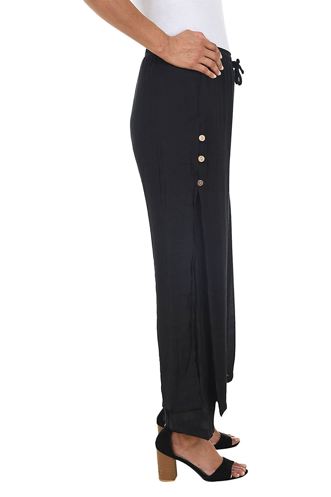 Black wide-leg pants worn by a person on a white background. Side shot.