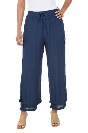 Blue wide-leg pants worn by a person on a white background