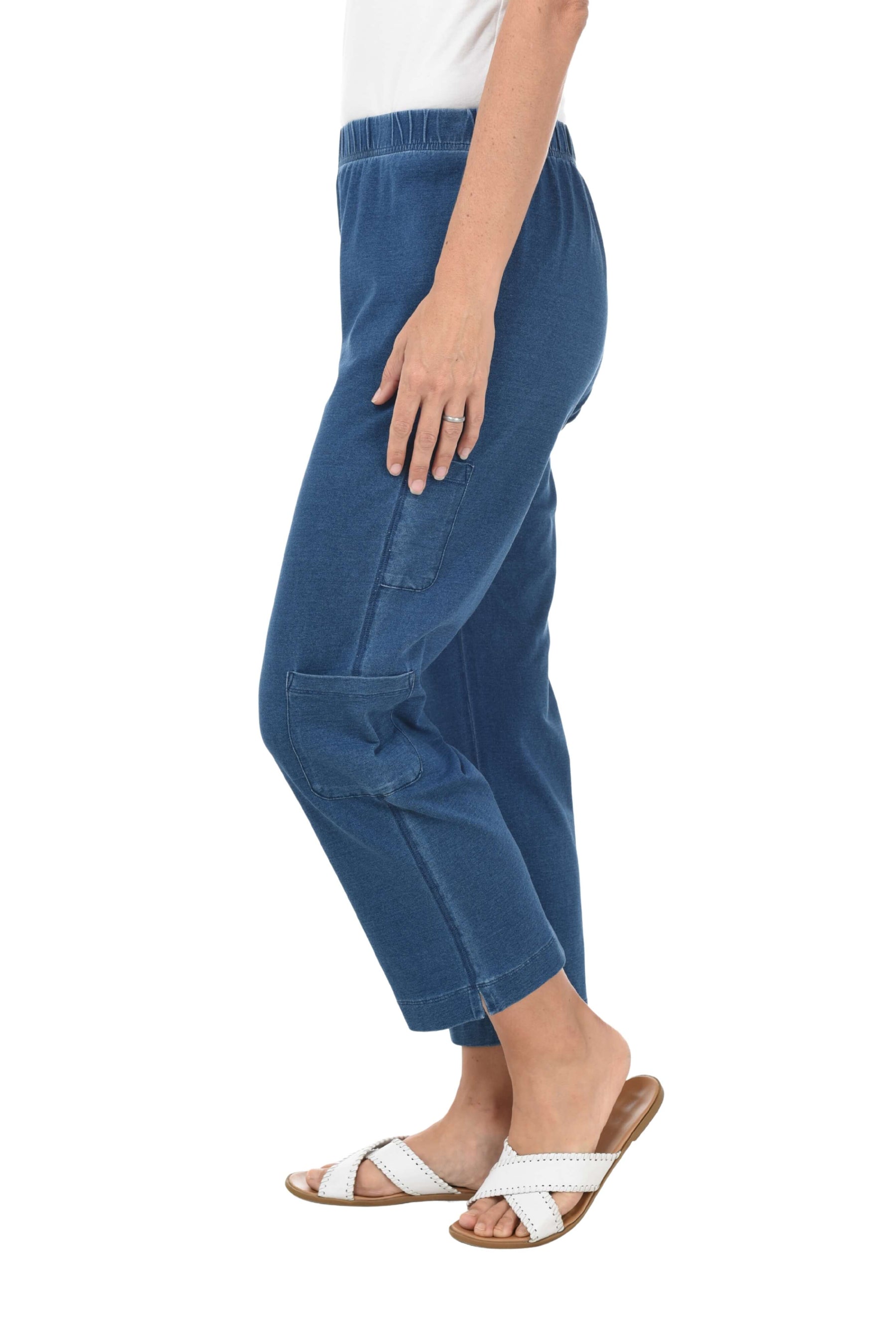 Blue pants worn by a person on a white background. Side shot.