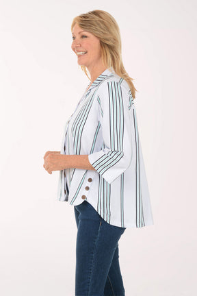 Woman wearing a white blouse with green stripes and blue jeans on a white background