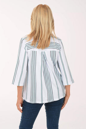 Woman wearing a white blouse with green stripes and blue jeans on a white background