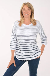 Woman wearing a striped shirt and jeans on a white background