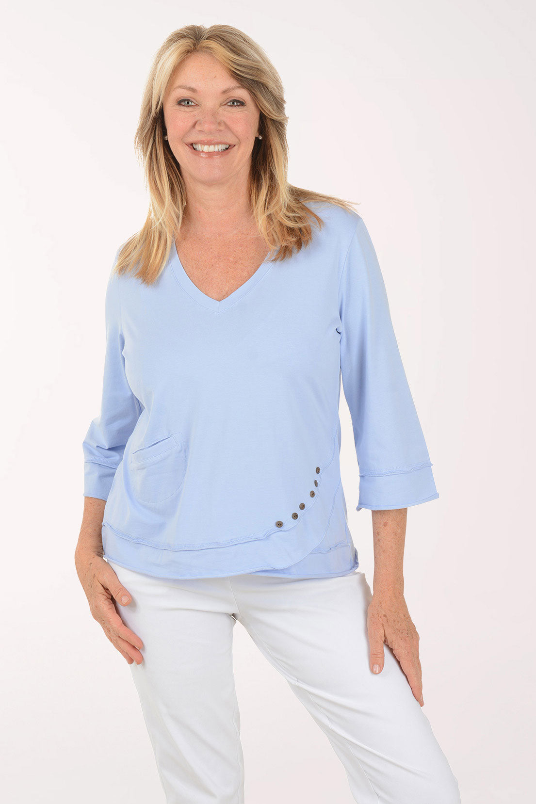 Woman wearing a light blue top with a white background