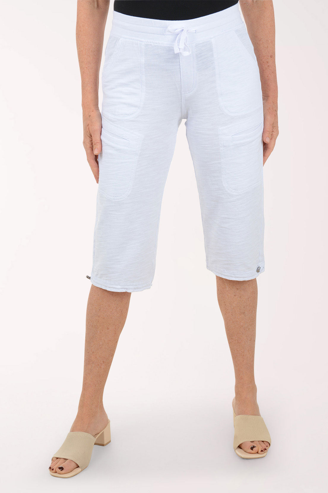Person wearing light blue capri pants on a white background