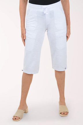 Person wearing light blue capri pants on a white background