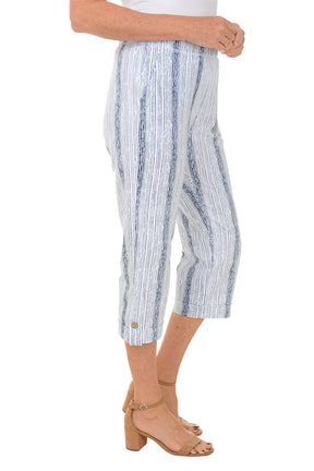 Blue and white striped pants worn by a person on a white background. Side shot.