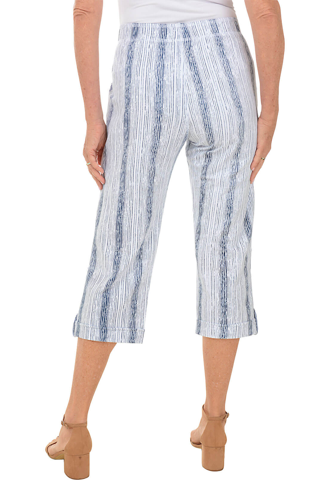 Blue and white striped pants worn by a person on a white background. Back shot.