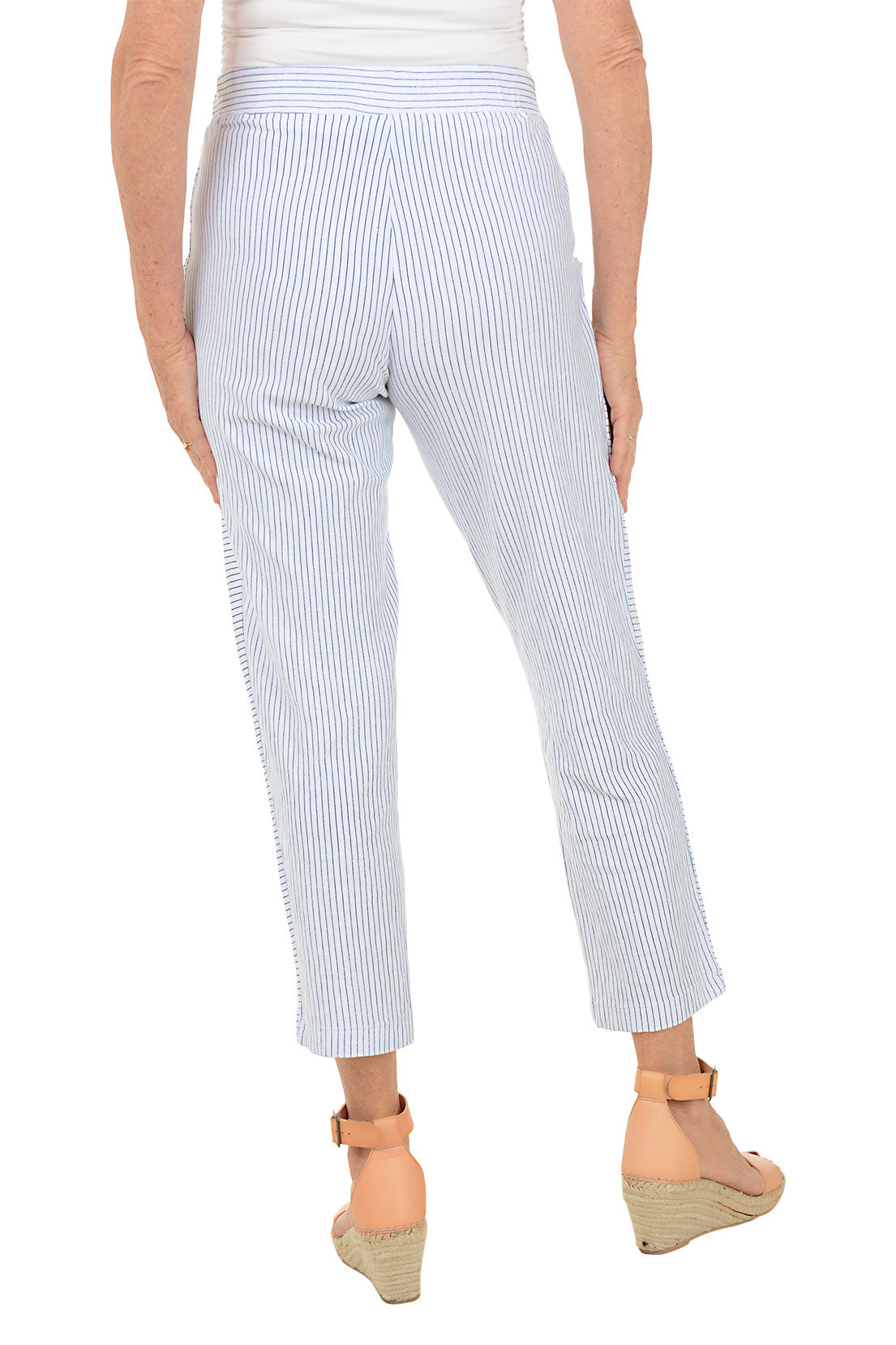 White pants with blue stripes worn by a person on a white background. Back shot.
