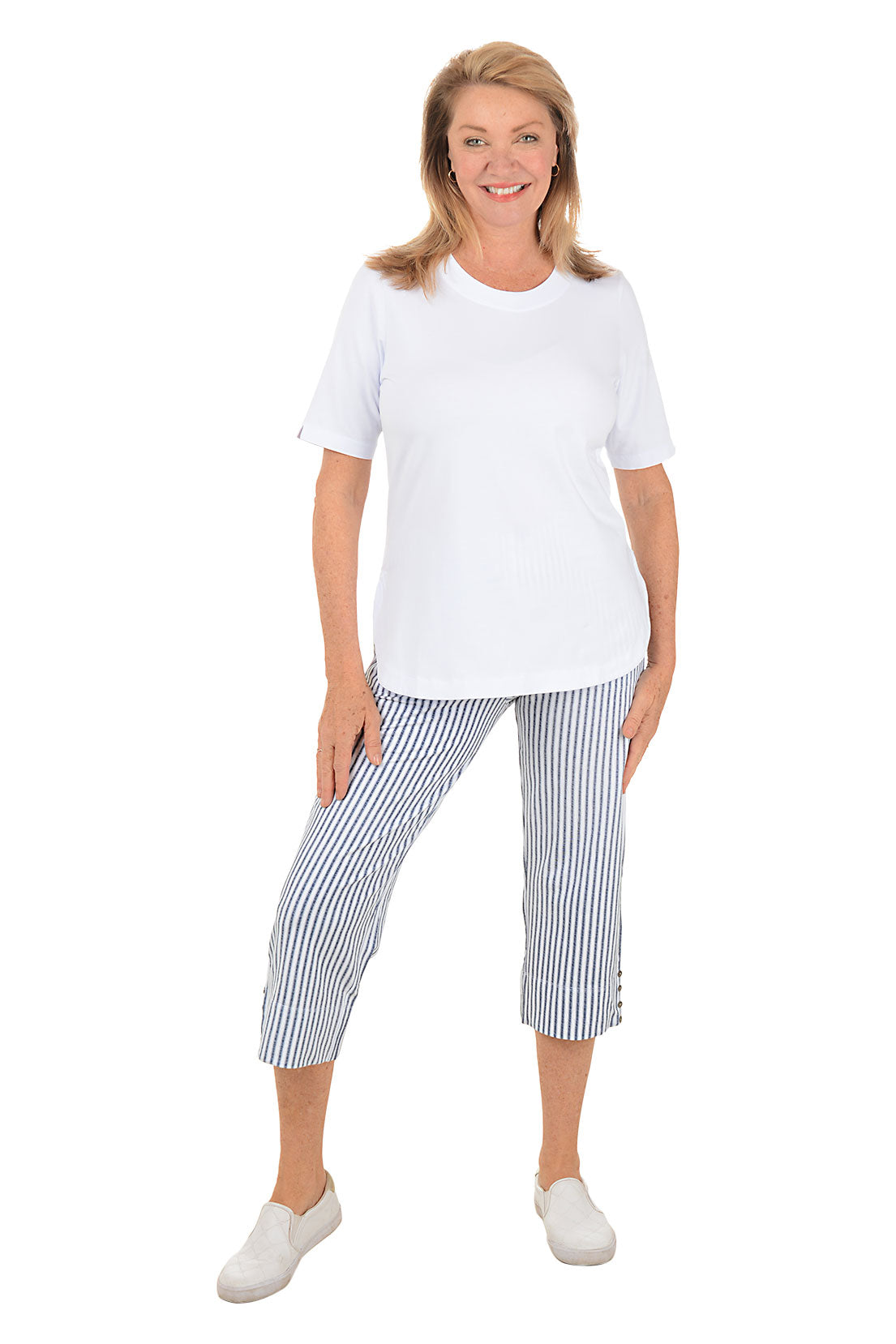 Woman wearing a white t-shirt and blue striped pants on a white background