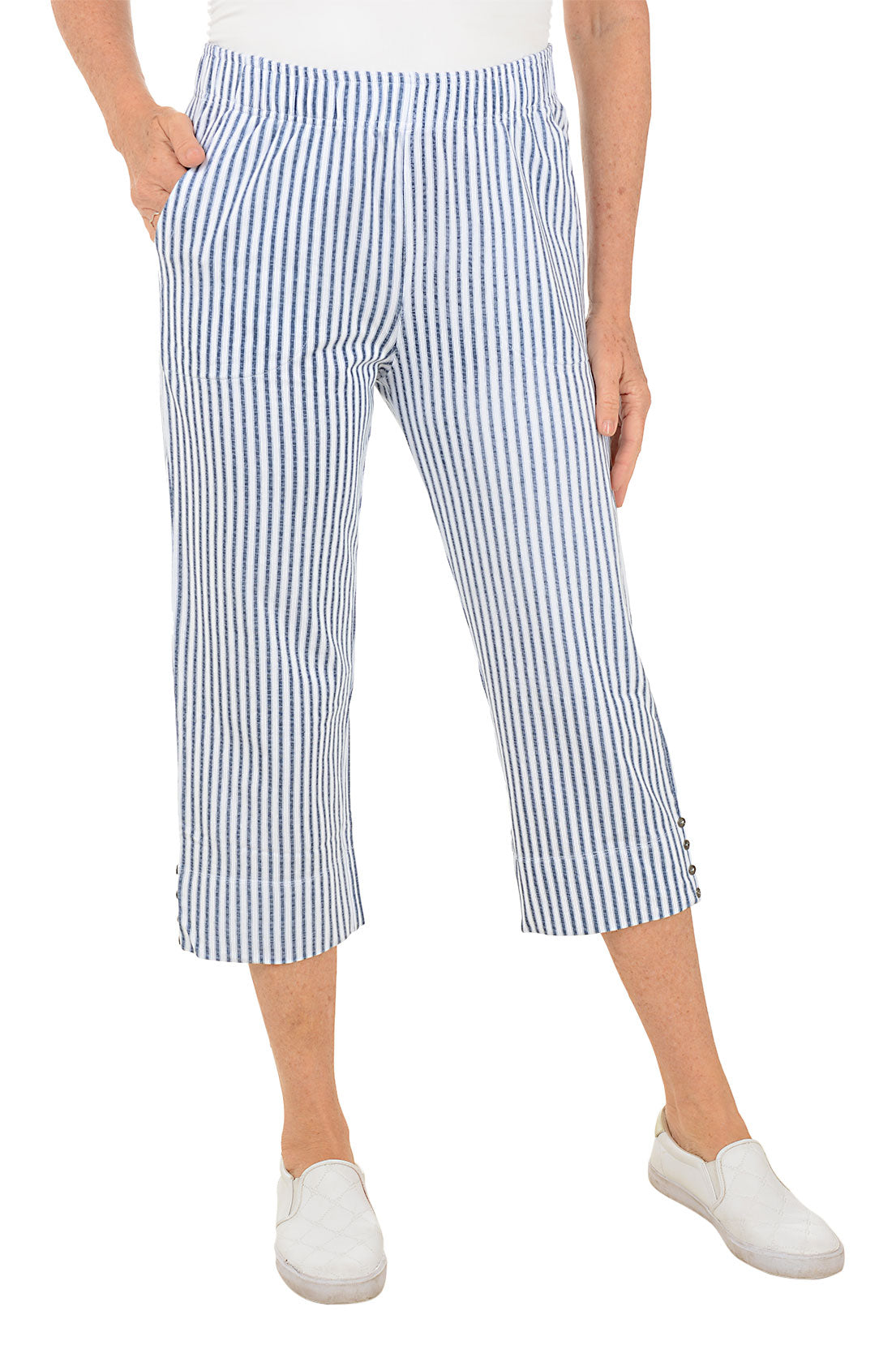 Person wearing blue and white striped pants on a white background.