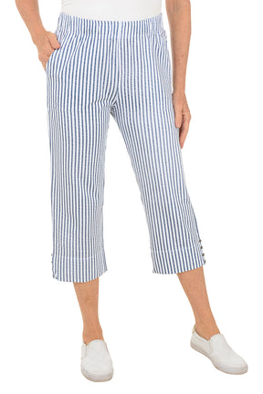 Person wearing blue and white striped pants on a white background.