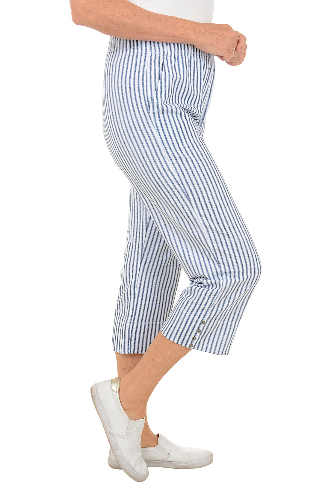 Person wearing blue and white striped pants on a white background. Side shot.