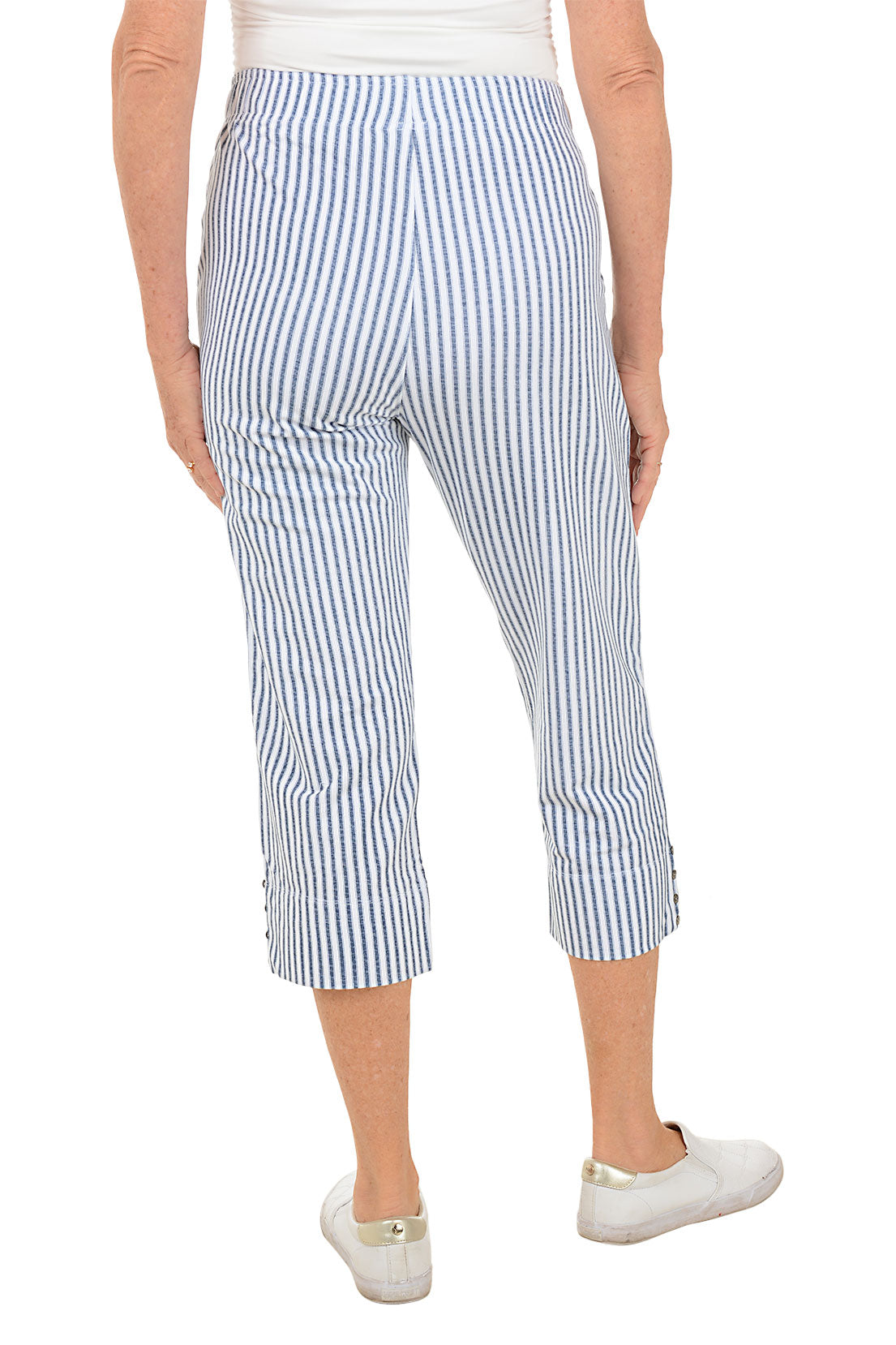 Person wearing blue and white striped pants on a white background. Back shot.