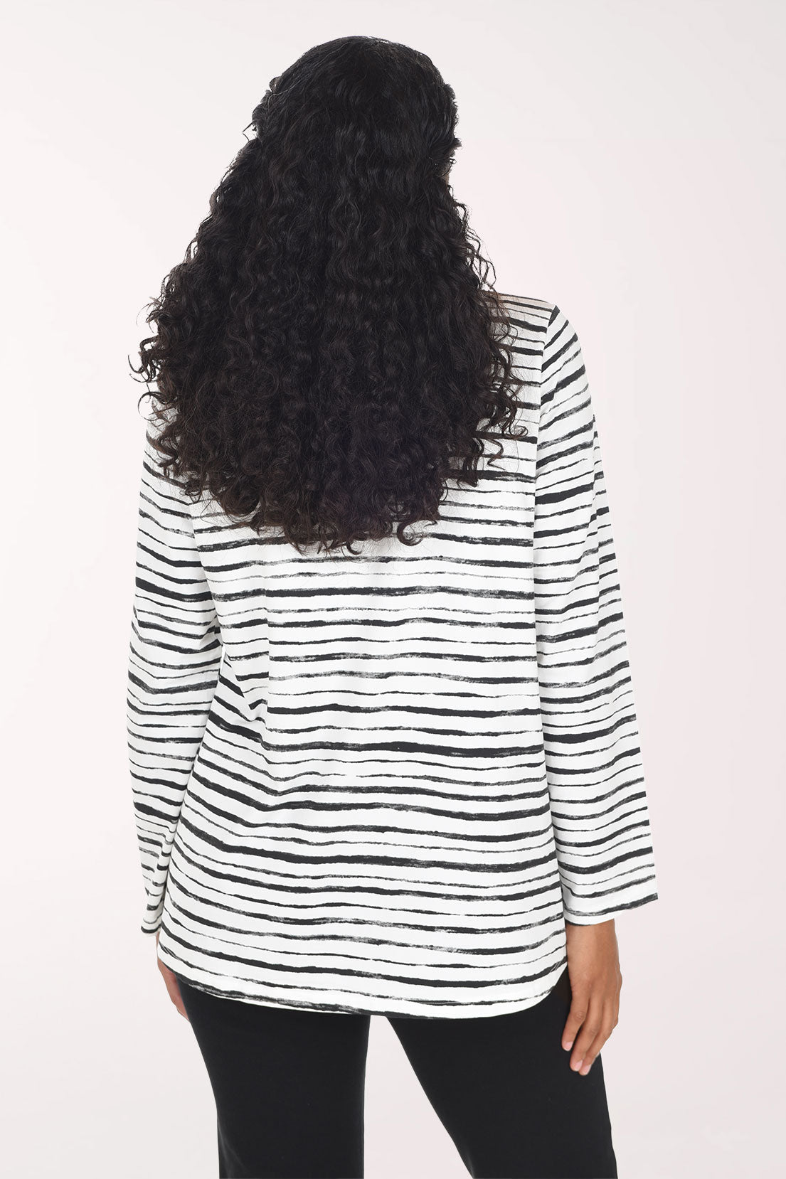 Woman wearing a black and white striped long sleeve top