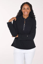 Woman wearing a black long sleeve half zip top