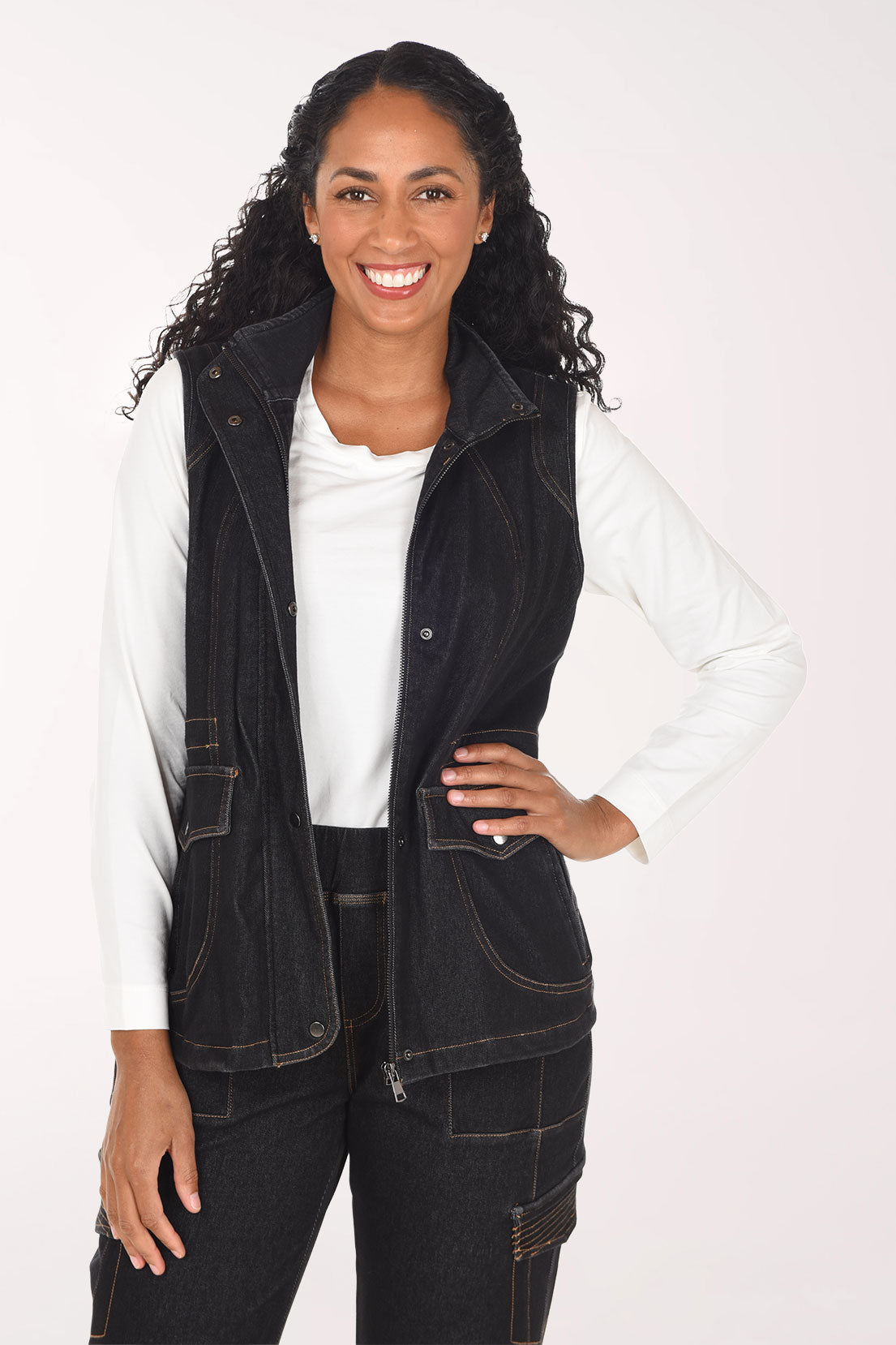 Woman wearing a sleeveless black denim vest