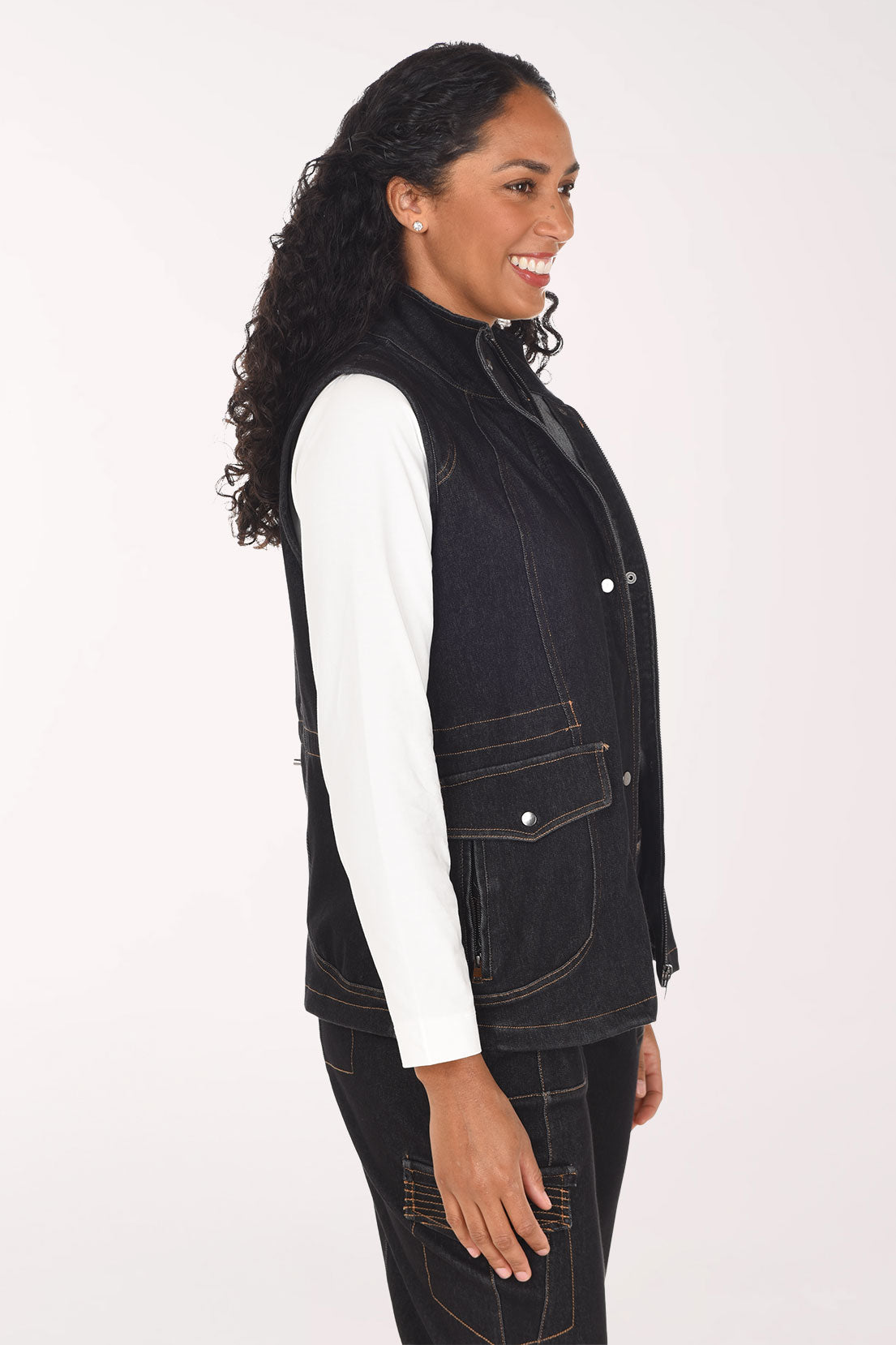 Woman wearing a sleeveless black denim vest