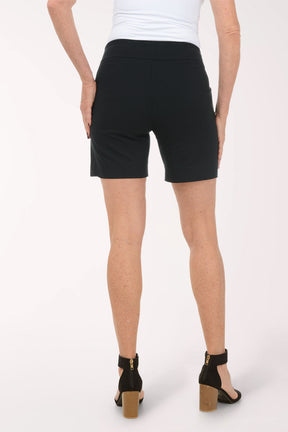 Person wearing black shorts on a white background