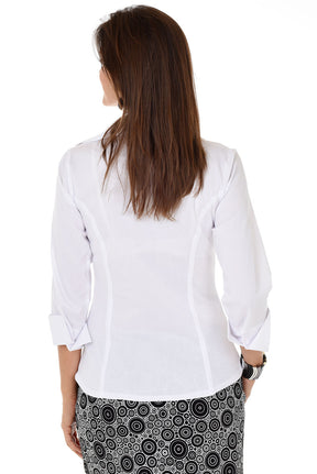 Woman wearing a white blouse with a patterned skirt on a white background