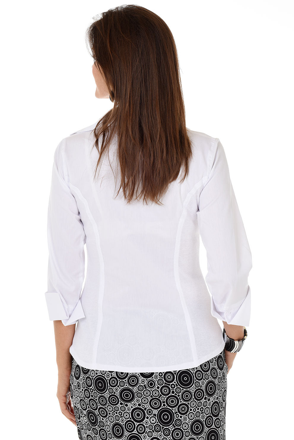 Woman wearing a white blouse with a patterned skirt on a white background