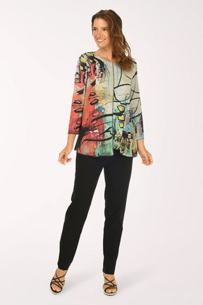 Woman wearing a colorful jacket and black pants on a white background