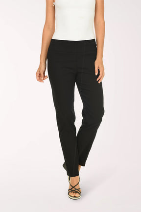 Person wearing black pants and a white top on a white background