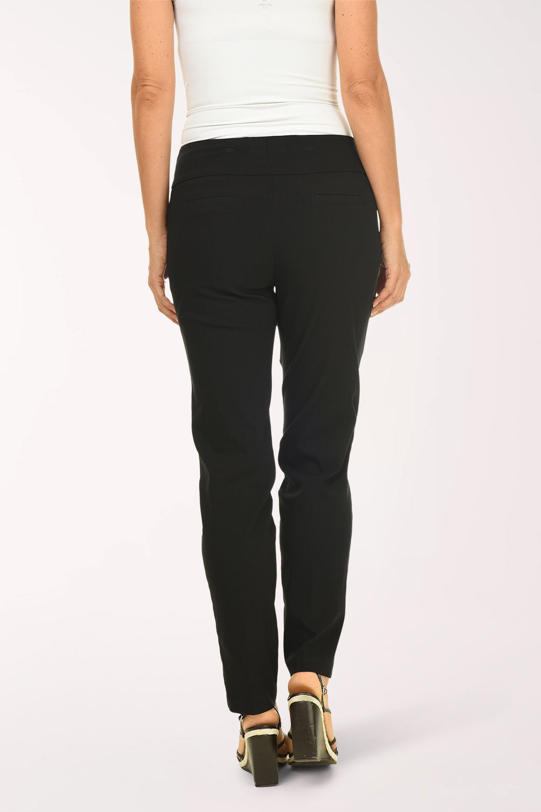 Person wearing black pants and a white top on a white background