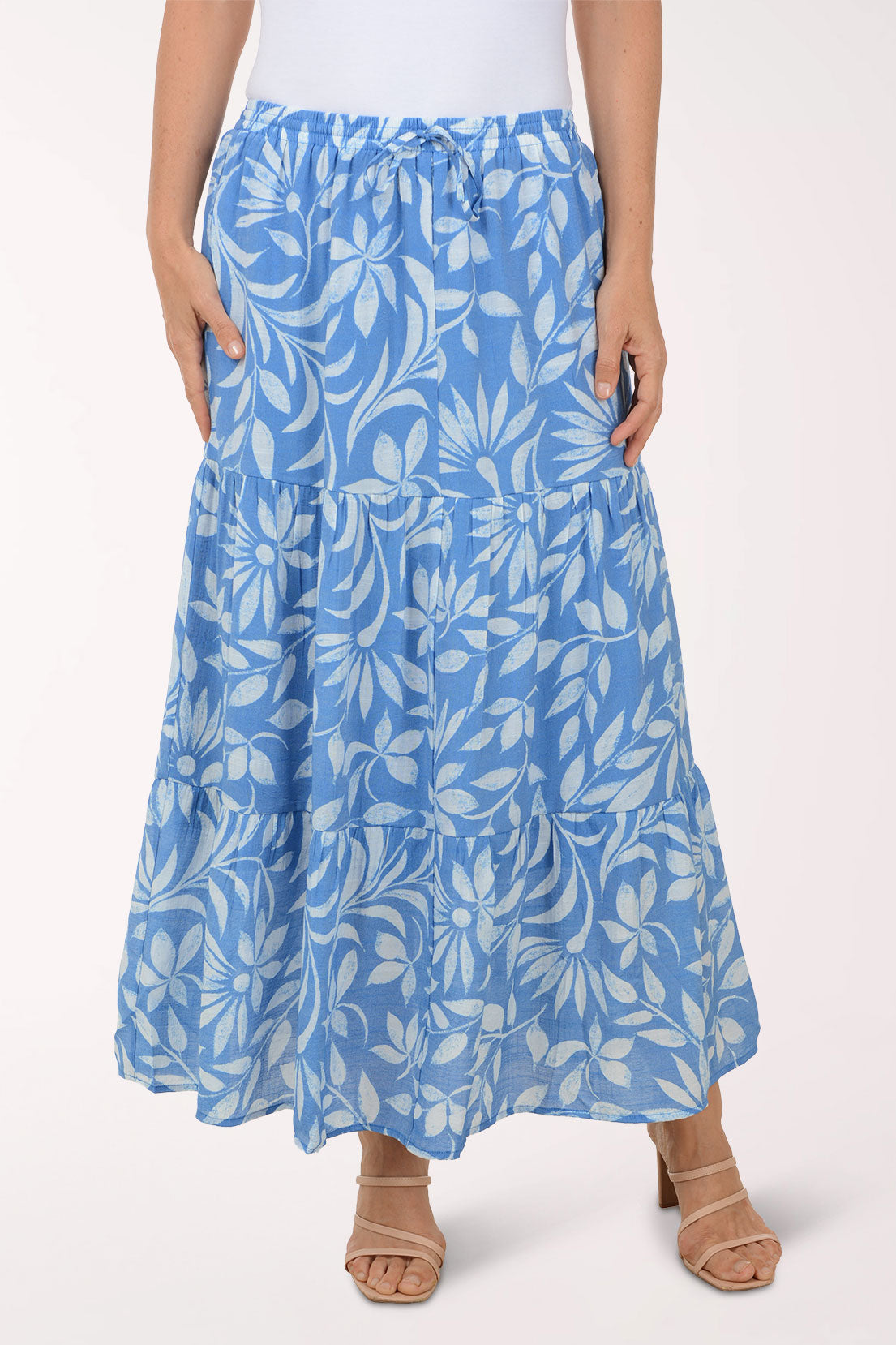 Blue floral skirt worn by a person on a white background