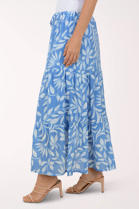 Blue floral skirt worn by a person on a white background