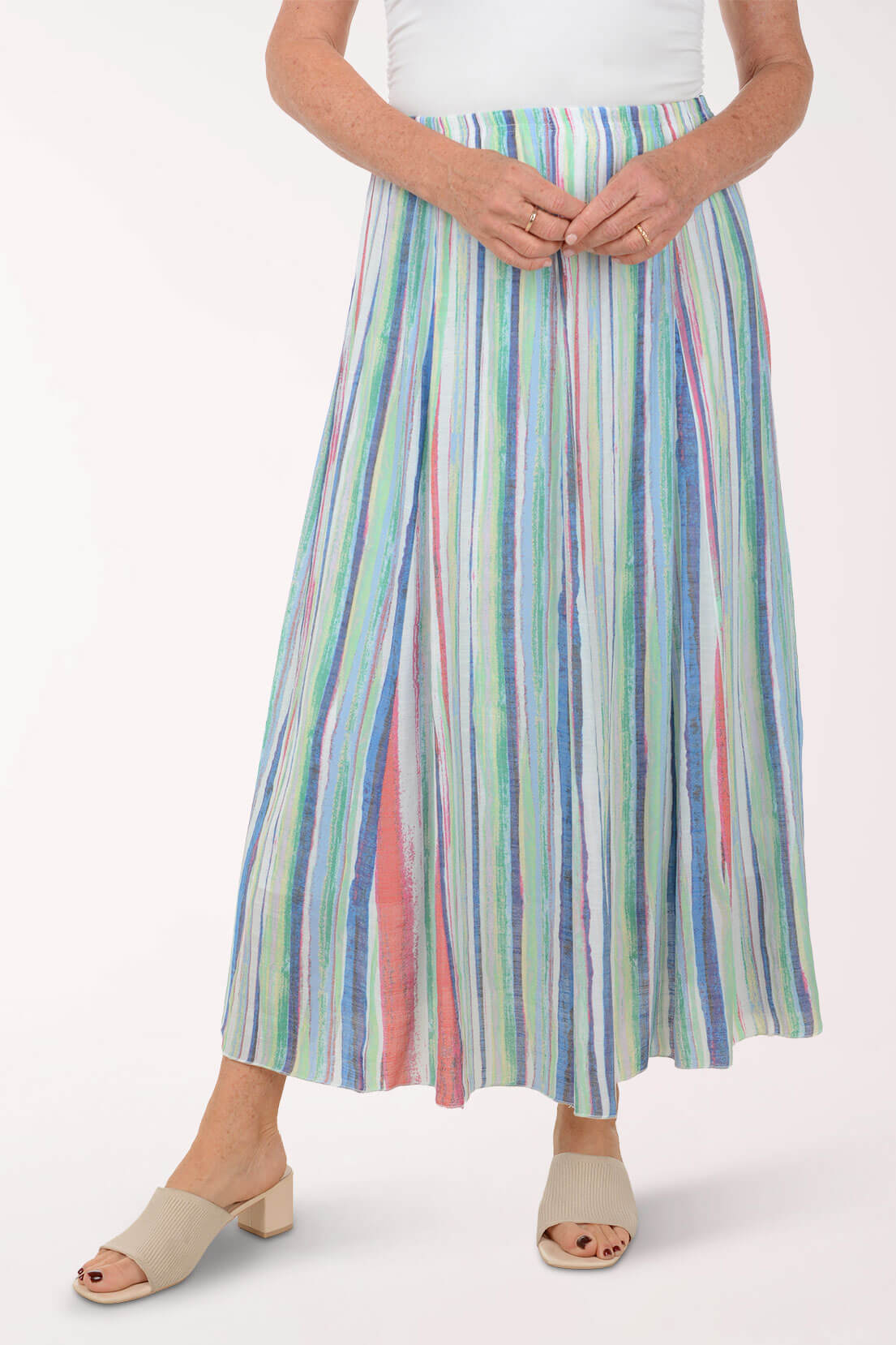 Person wearing a colorful striped skirt on a white background