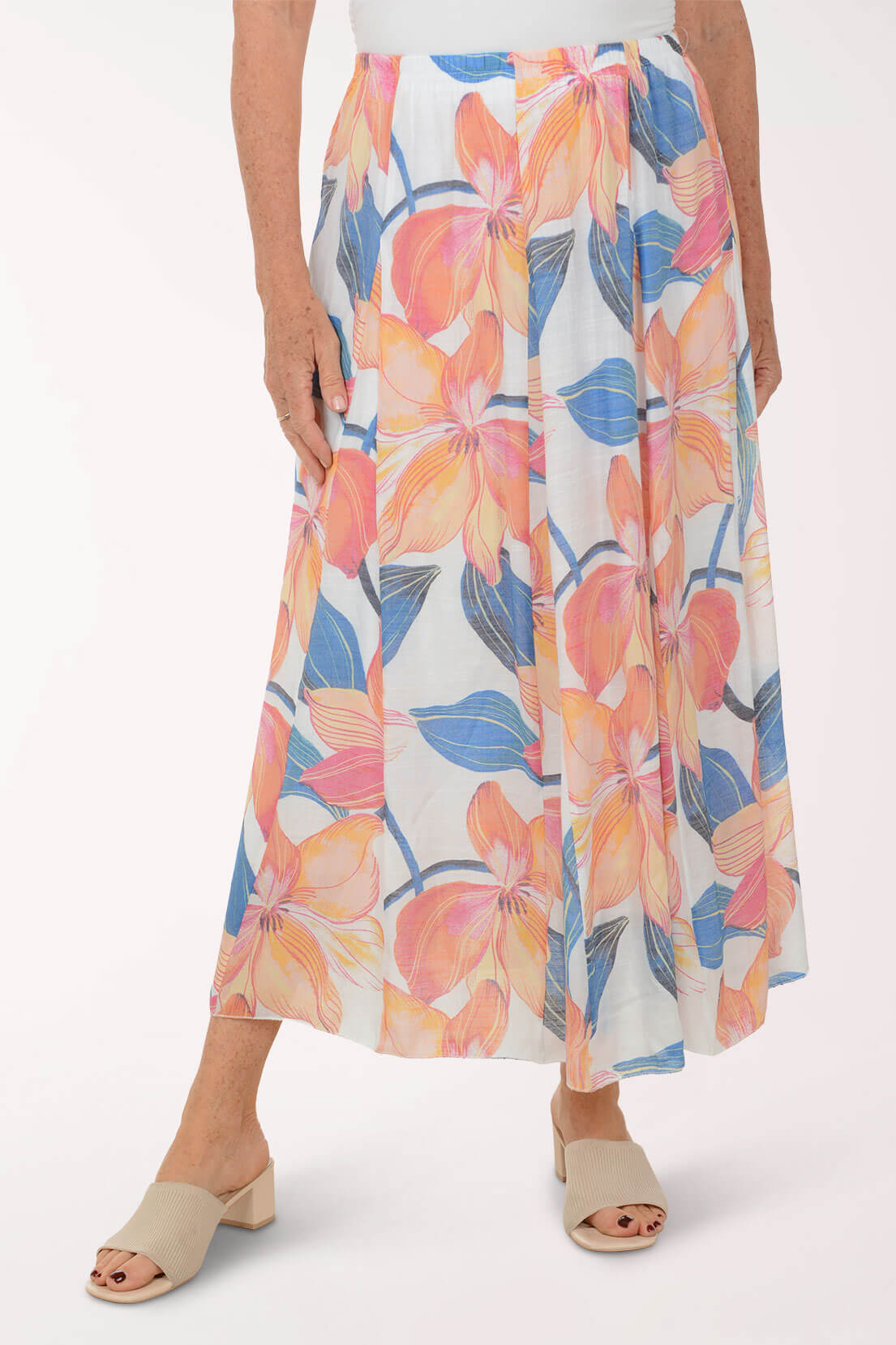 Woman wearing a colorful floral skirt on a white background