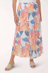 Woman wearing a colorful floral skirt on a white background