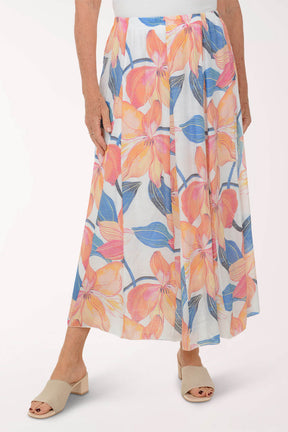 Woman wearing a colorful floral skirt on a white background