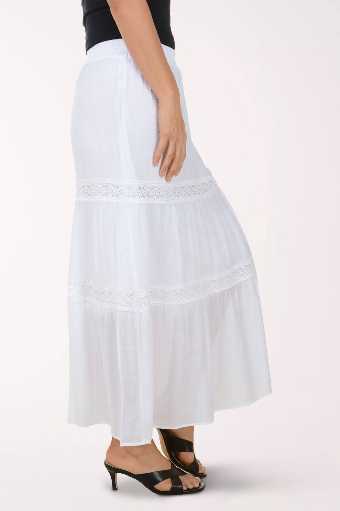 White skirt with lace details worn by a person on a white background