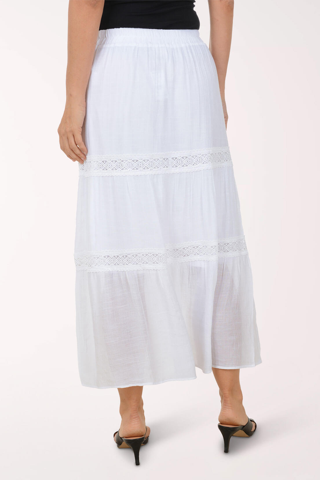 White lace-trimmed skirt worn by a person on a white background